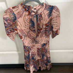 Free people romper, super unique has a key hole opening in the front!